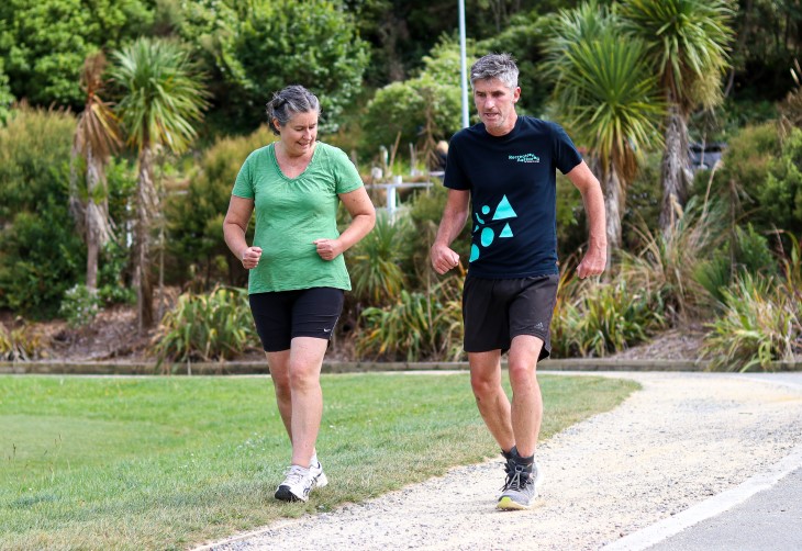 Andrew runs with his sister on a path