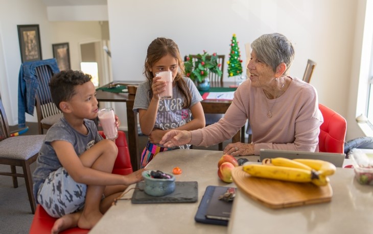 Grandmother and children drinking smoothies