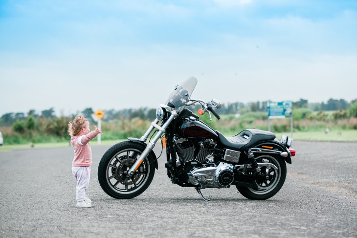 Harley stands in front of a motorbike