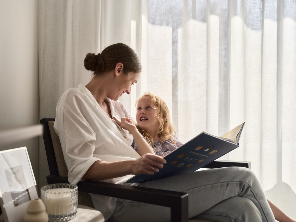Parent and child sitting reading a picture book