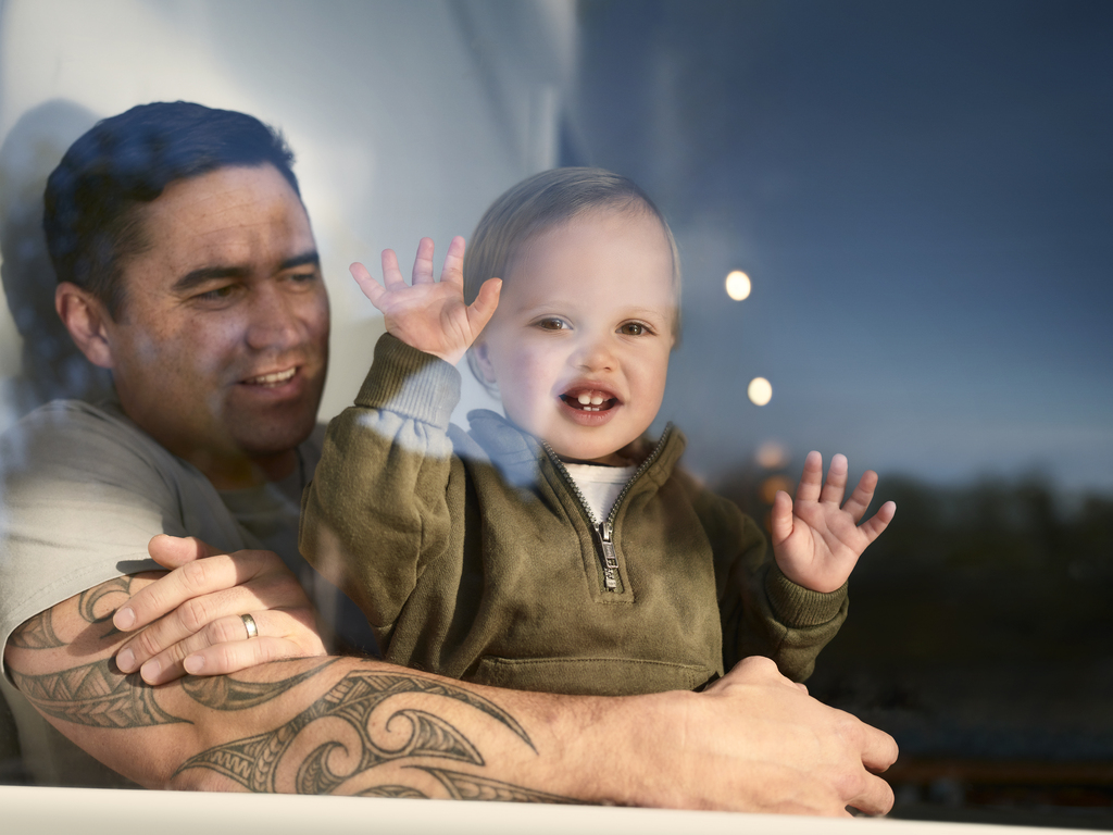 parent and child sitting and looking out a window