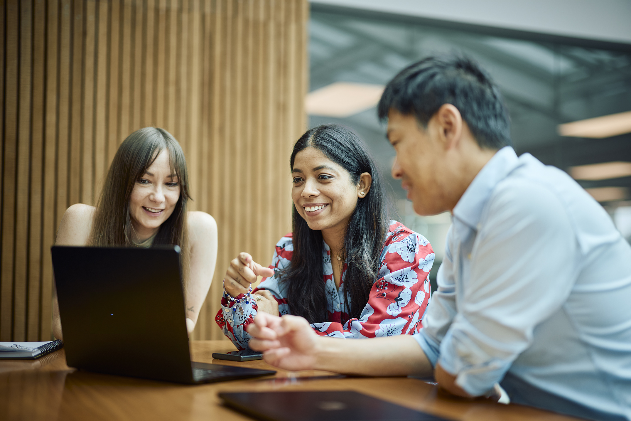 Person reading on laptop sitting at table