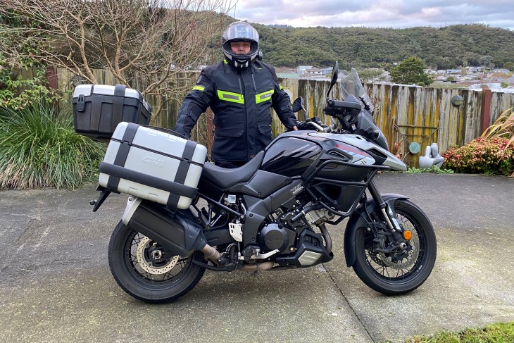 Dave Keilty poses for a photo with his motorbike in his safety equipment