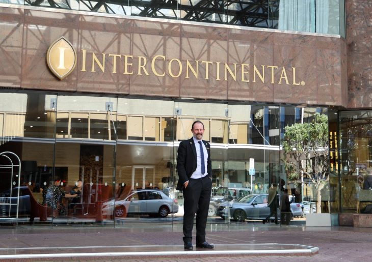 Jason Eade, the Head Concierge at The InterContinental Hotel Wellington, stands in front of the hotel