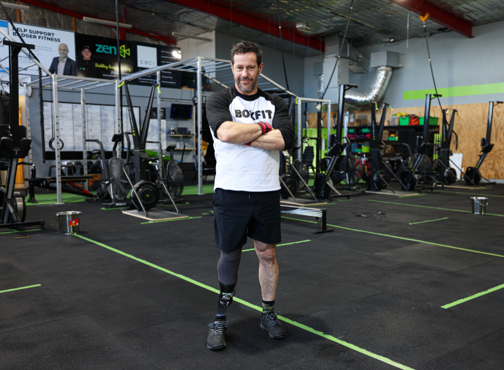 CrossFit competitor Craig Harrington standing in the gym and looking at the camera with his arms fol