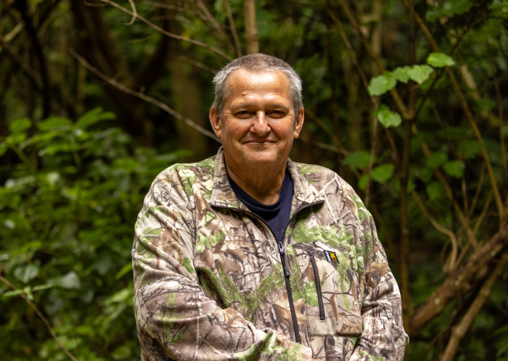A close-up photo showing George Thompson smiling in the bush.