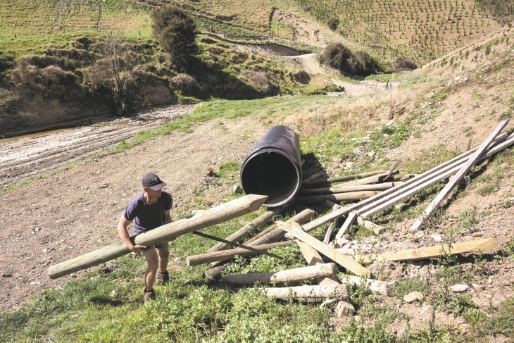 Harry Gaddum moving fence posts on his farm.