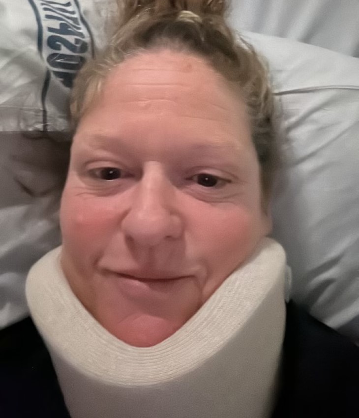 A close-up shot of Jacinta O’Donohue's face, showing her wearing a neck brace.