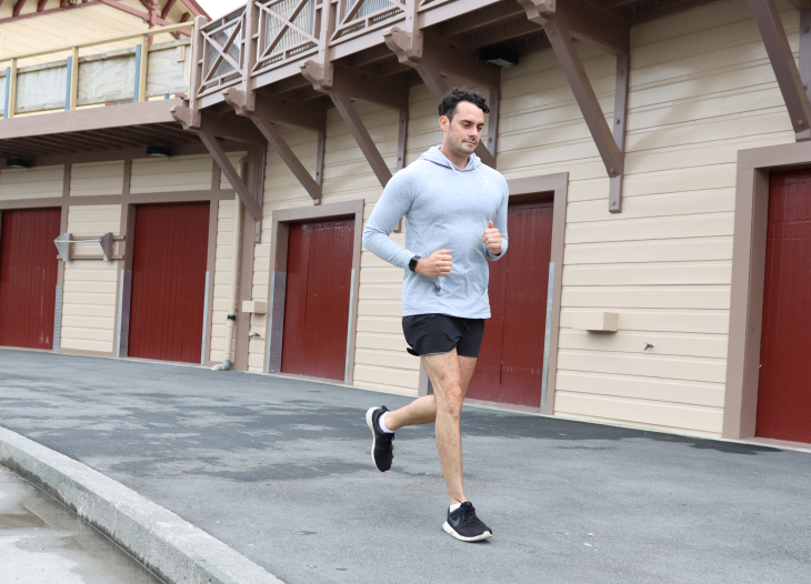Liam Olson running in front of boat sheds. 