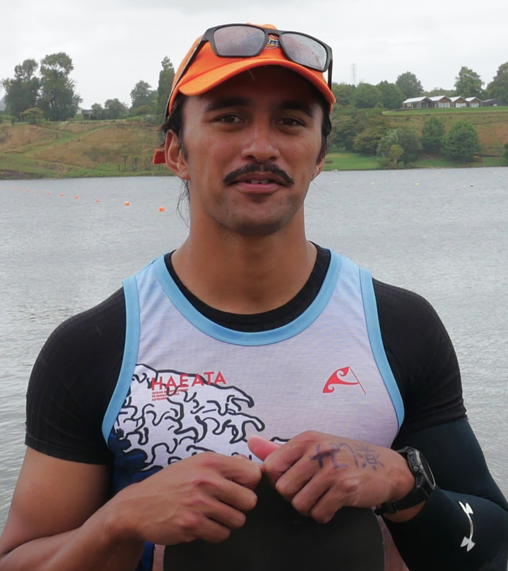 A close-up head and shoulders photo of Peter Cowan with a lake in the background.