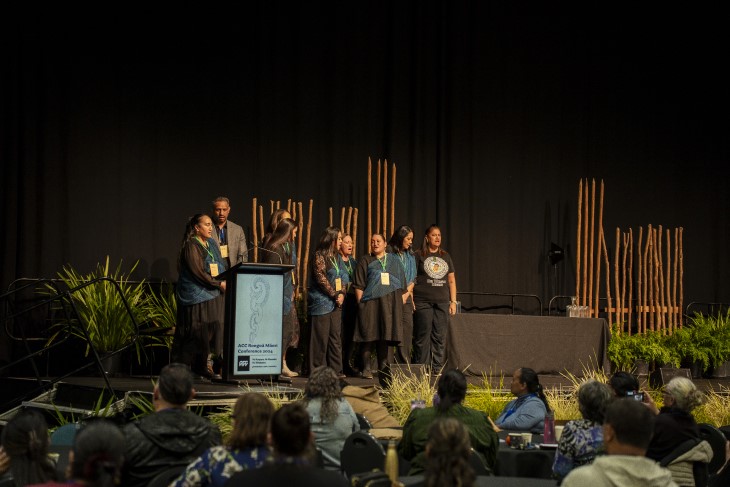 A group of people on stage at the ACC Rongoā Māori Conference.