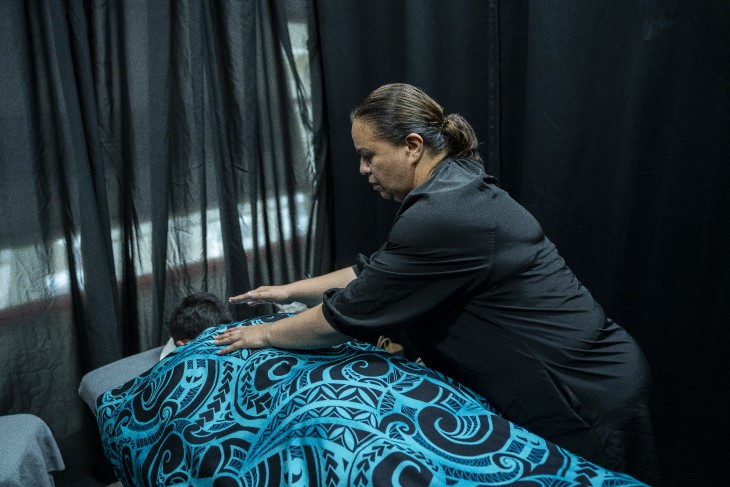 A rongoa Māori practitioner provides healing to a client.